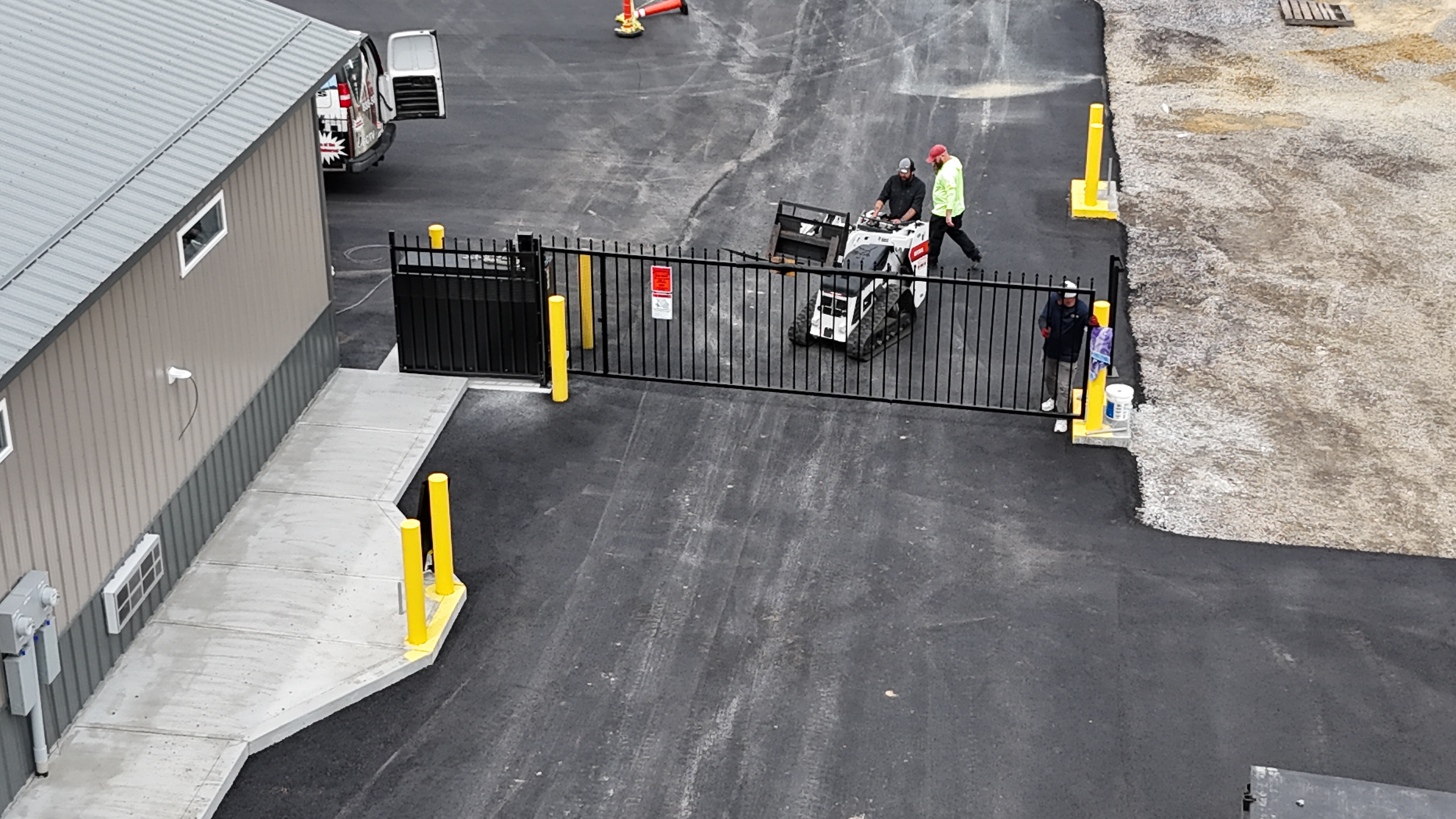 Vertical pivot gate installation with workers at the entry lane