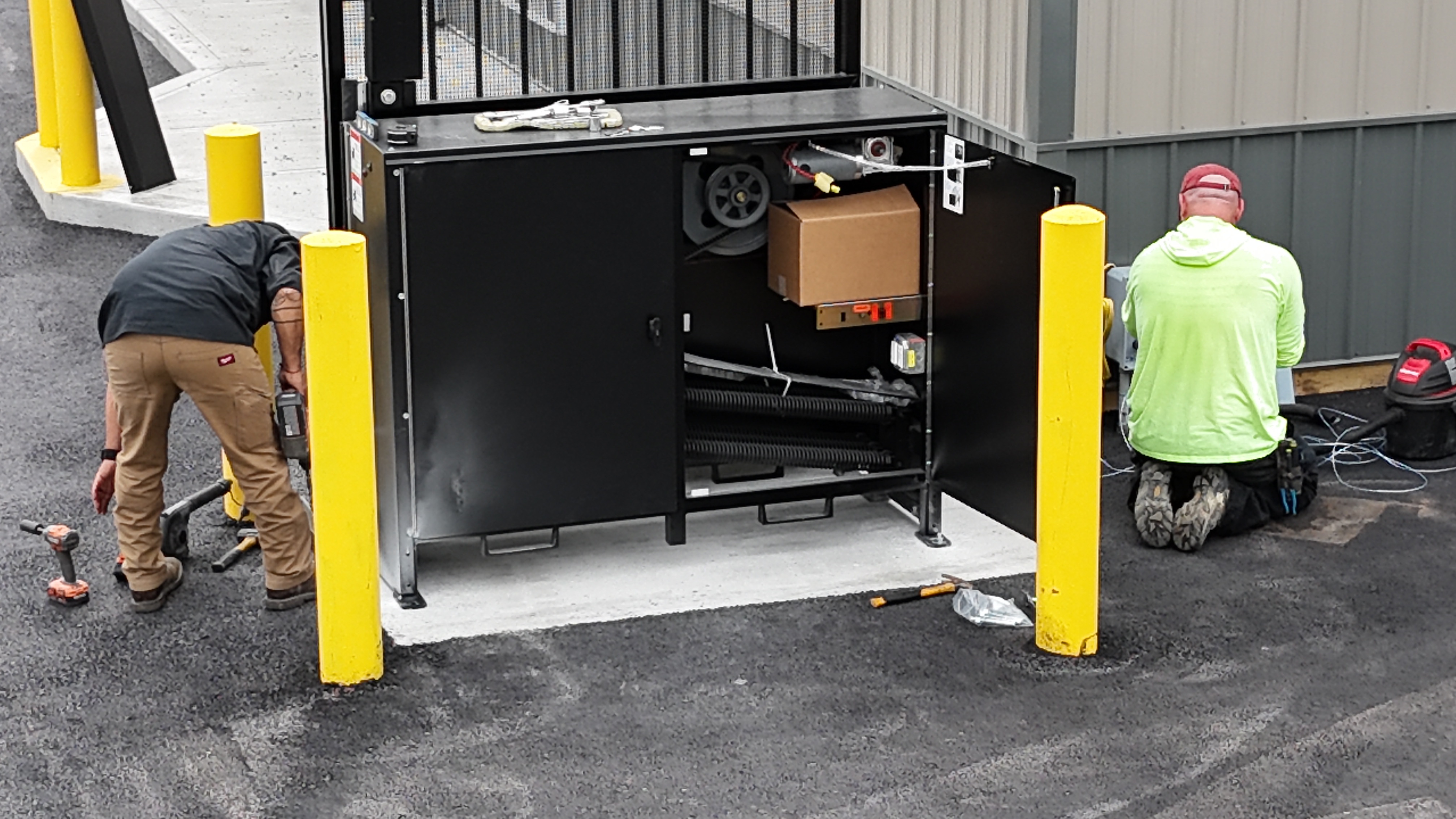 Gate operator housing and workers during installation