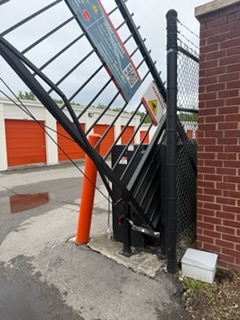 Close-up of broken weld at gate base rail