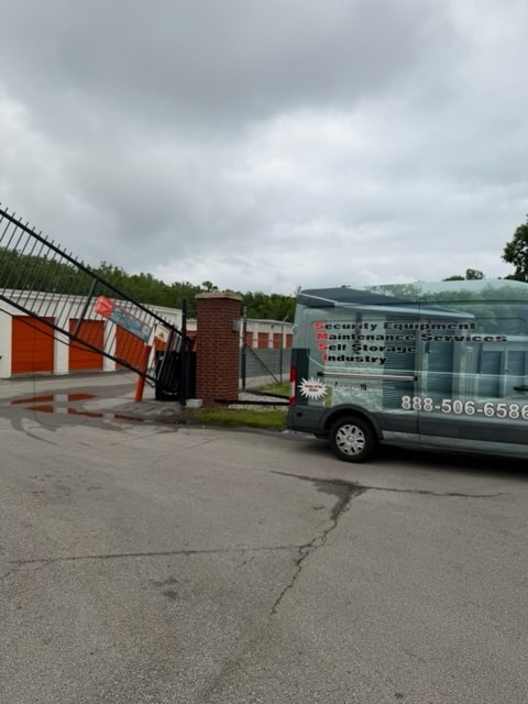 SMS van on site with damaged gate visible in background