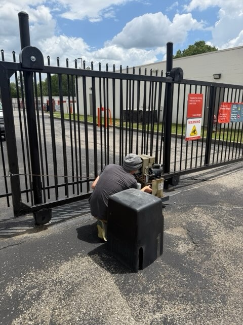 Technician working gate operator back into position