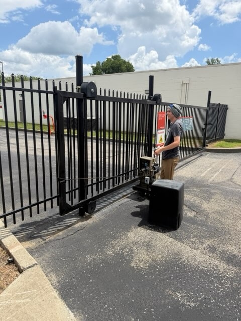 SMS technician repairing gate operator after trailer impact