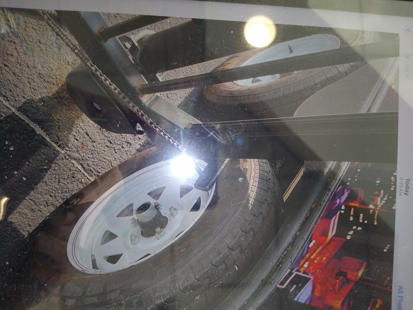 Close-up of gate and trailer wheel entanglement