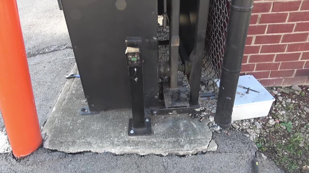 Gate operator base anchored to the concrete pad