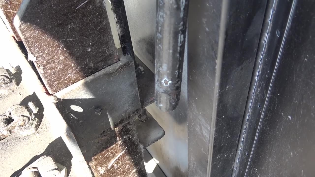 Close-up of gate panel hardware and chain