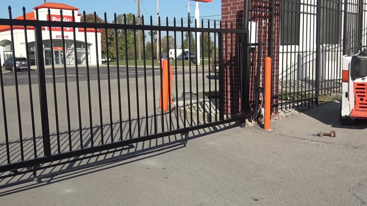 Finished gate panel in place across the entry lane with bollards