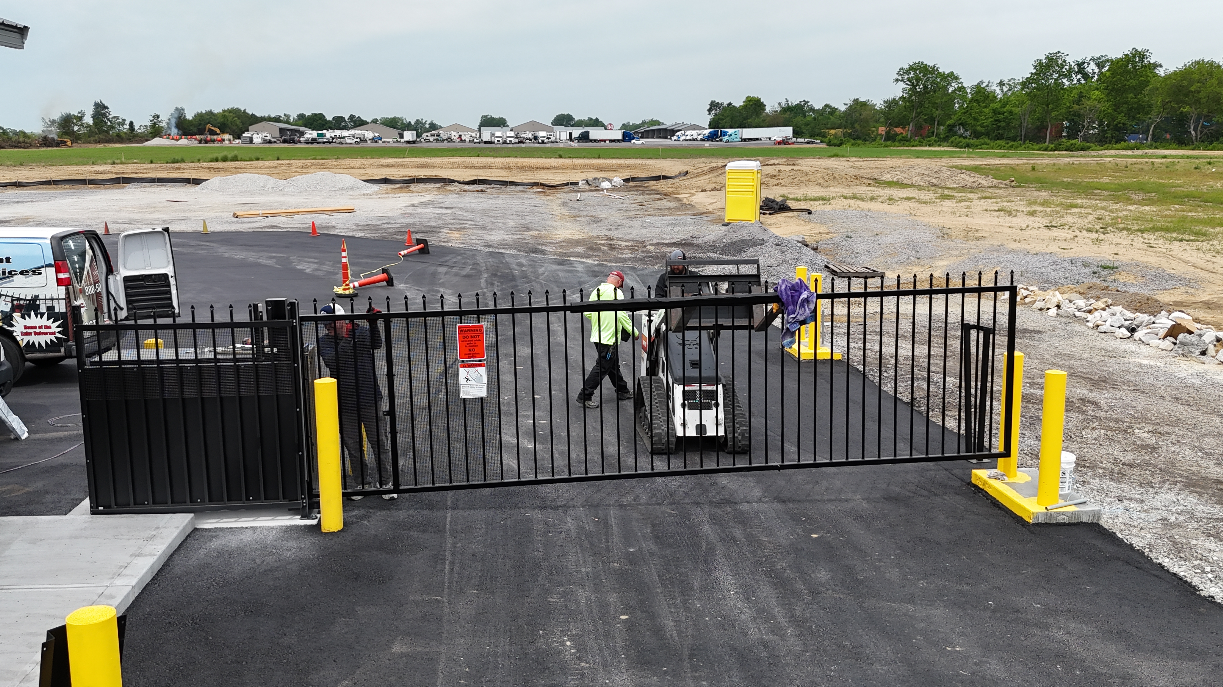 Completed vertical pivot gate installation at a storage facility entrance