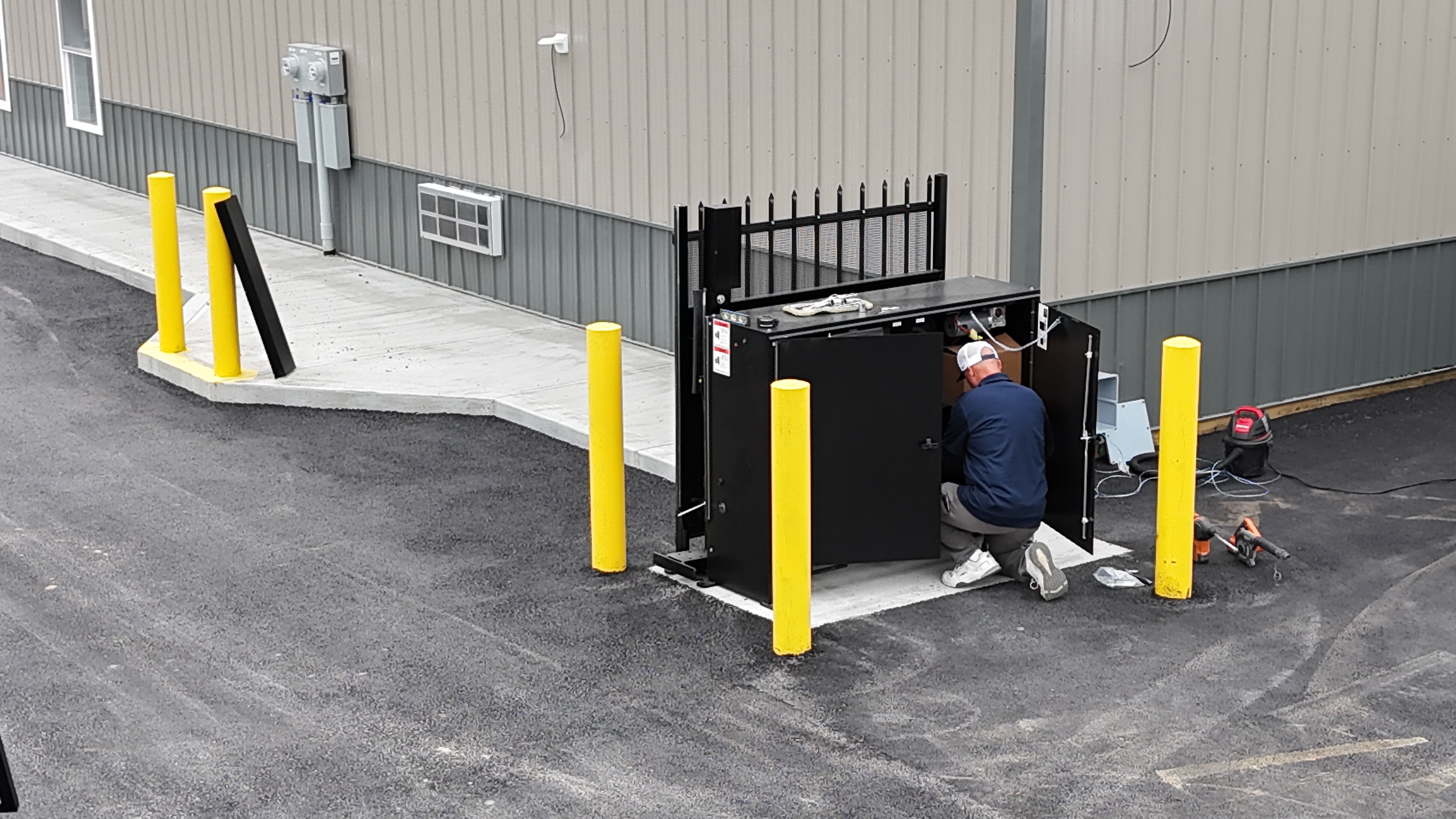 Wide site view with gate installation materials and work area